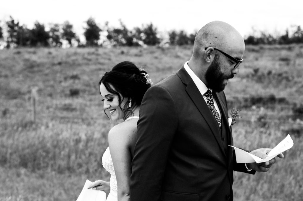 Bride and groom reading vows back to back on their wedding day | www.candidconnectionphotography.com